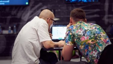 Infosecurity Europe attendees browse on a laptop