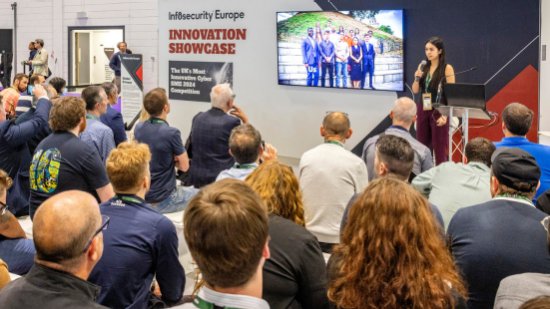Infosecurity Europe attendees watch a cybersecurity conference session at the Geek Street stage