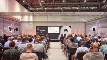 Infosecurity Europe attendees watch a speaker present a Strategy Talk conference session 