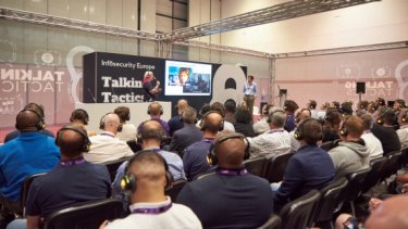 Rows of attendees watch a Talking Tactics conference session at Infosecurity Europe