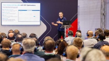 Infosecurity Europe attendees watch a speaker present a Strategy Talk conference session