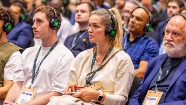 Attendees of Infosecurity Europe wearing headphones