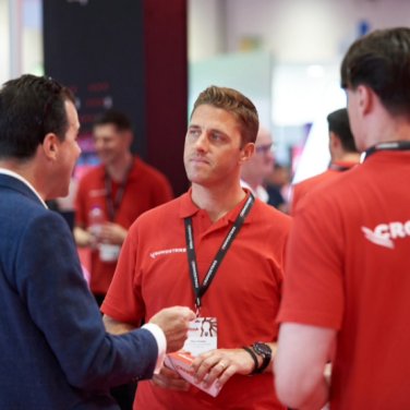 Crowdstrike employees chat with an Infosecurity Europe attendee