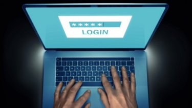 A hand on laptop with login image on screen
