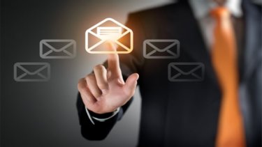 A hand touching a screen with mail image