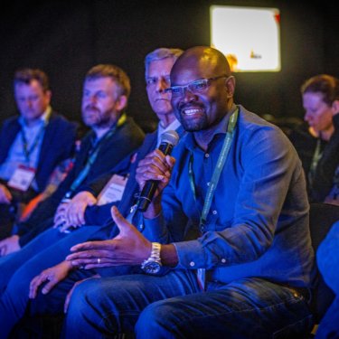 Infosecurity Europe attendees smiling during a conference session